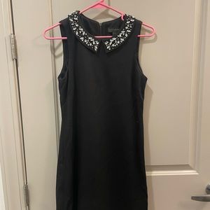 Black sleeveless dress with embellished collar